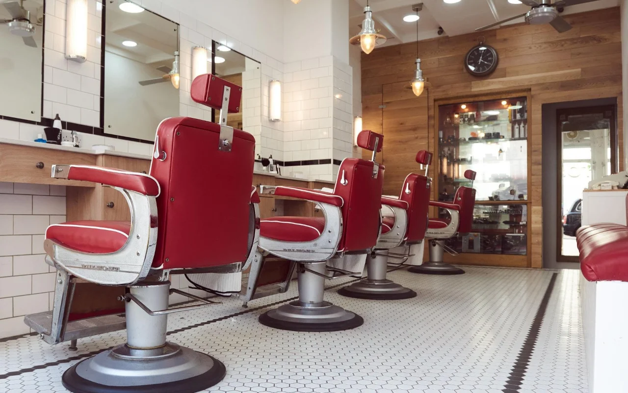 Row of red Belmont barber chairs at Peters Court