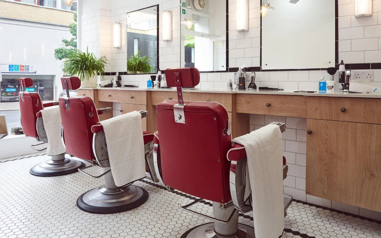Belmont chairs facing subway-tiled mirrors
