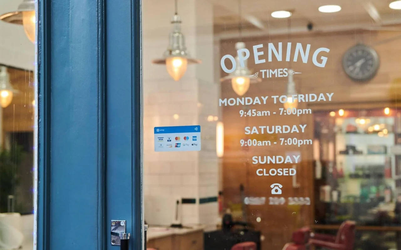 Opening times painted on the salon window